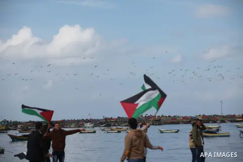Supporters of Palestinian People's Party take part a protest demanding for reconstruction of the houses which were destroyed during the recent Israeli war, at the seaport near the coast of Gaza city, February 18, 2015. A...