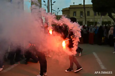 Egyptian students who are support ousted President Mohamed Morsi and the Muslim Brotherhood light up flares as others protest against the military rule, in Cairo University on February 18, 2015. Due to the escalation of...