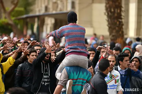 Egyptian students who are support ousted President Mohamed Morsi and the Muslim Brotherhood shout slogans during protest against the military rule, in Cairo University on February 18, 2015. Due to the escalation of stude...