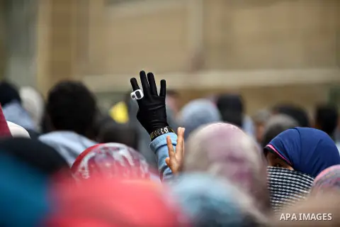 An Egyptian student who support ousted President Mohamed Morsi and the Muslim Brotherhood, flashes Rabaa sign during protest against the military rule, in Cairo University on February 18, 2015. Due to the escalation of s...