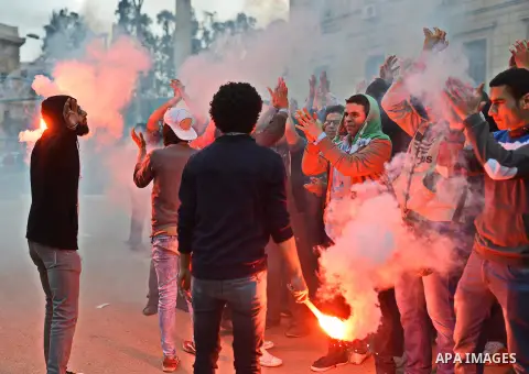 Egyptian students who are support ousted President Mohamed Morsi and the Muslim Brotherhood light up flares as others protest against the military rule, in Cairo University on February 18, 2015. Due to the escalation of...