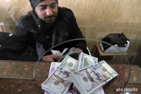 A Palestinian money changer counts money at an currency exchange office, in Rafah in the southern Gaza Strip, February 19, 2015. The European Commission announced on Tuesday February 17, the EU allocated 212 million euro...