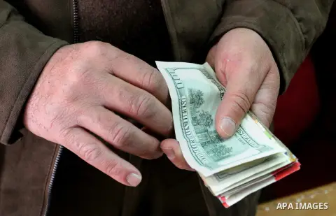 A Palestinian money changer counts money at an currency exchange office, in Rafah in the southern Gaza Strip, February 19, 2015. The European Commission announced on Tuesday February 17, the EU allocated 212 million euro...