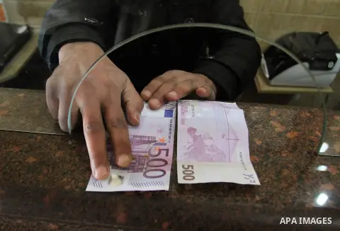 A Palestinian money changer counts money at an currency exchange office, in Rafah in the southern Gaza Strip, February 19, 2015. The European Commission announced on Tuesday February 17, the EU allocated 212 million euro...