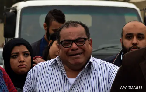Relatives and supporters of Egyptian activist Alaa Abdel Fattah react after the verdict in his trial at a police institute in Cairo's Tora prison on February 23, 2015. Fattah, a leading dissident in the 2011 uprising tha...
