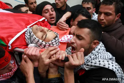 Palestinian mourners carry the body of 19-year old Palestinian Jihad al-Jaafari, who was shot dead on the roof of his house after Israeli soldiers entered the Dheishe refugee camp, near the West Bank city of Bethlehem be...