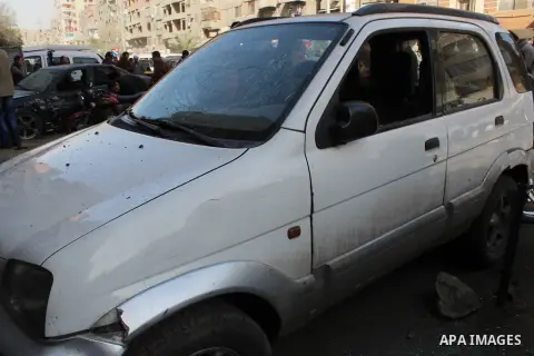 Photo taken on Feb. 26, 2015 shows a damaged car near one of the blast site in front of a mobile shop in Cairo, Egypt. Six bombs detonated in the greater Cairo area in Egypt early on Thursday morning, killing one and inj...