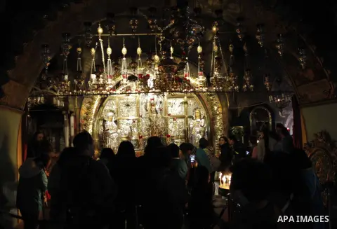Christian pilgrims pray at the Church of the Holy Sepulchre in Jerusalem's Old city February 26, 2015. A fire damaged a Greek Orthodox seminary in Jerusalem on Thursday and "anti-Christian" graffiti was found at the scen...