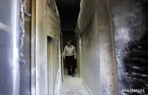 An Israeli man looks at damage at a Greek Orthodox seminary in Jerusalem February 26, 2015. A fire damaged a Greek Orthodox seminary in Jerusalem on Thursday and "anti-Christian" graffiti was found at the scene in what I...