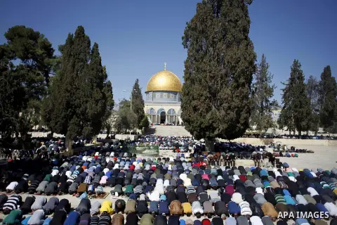 Palestinian Muslim worshipers perform the Friday prayer outside of the Dome mosque of the Rock in the Al-Aqsa mosques compound in Jerusalem's old city on February 27, 2015. Photo by Muammar Awad