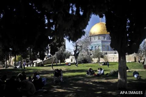 Palestinian Muslims walk outside the Dome of the Rock following Friday prayer in the Al-Aqsa mosques compound in Jerusalem's old city on February 27, 2015. Photo by Muammar Awad