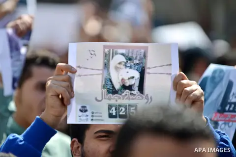 Egyptian students who support ousted President Mohamed Morsi and the Muslim Brotherhood shout hold a picture of detained student Rawda Jamal, during protest against the military rule, in Cairo University on March 1, 2015...