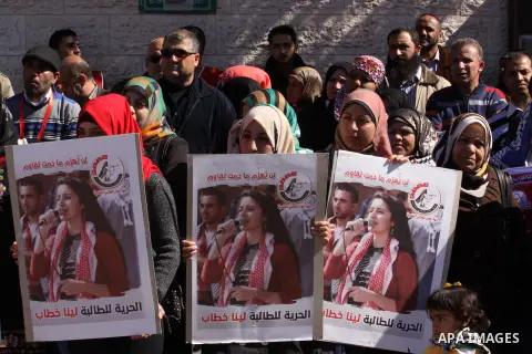 Palestinians take part a protest demanding the release of the prisoner Lina Khattab held in Israeli jails, in front of the Red Cross office in Gaza City, on March 02, 2015. Photo by Mohammed Asad