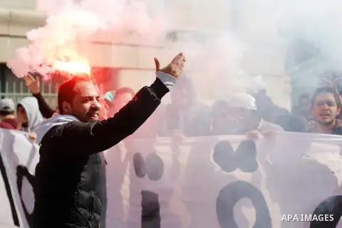 Al-Zamalek soccer club fans known as 'Ultras White Knights" light flares and shout slogans during a protest against interior ministry after the riot that killed more than 20 soccer fans last month, at Cairo University on...