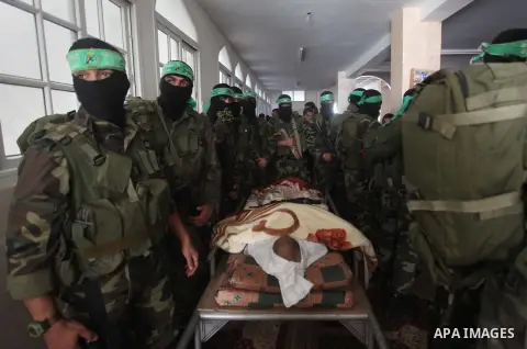 Militants of Ezz eddin al-Qassam brigades take part a funeral of a co-founder of the Hamas movement Hammad Al-Hasanat in Nuseirat refugee camp in the central of Gaza strip, on March 03, 2015. Al-Hasanat, was deported by...