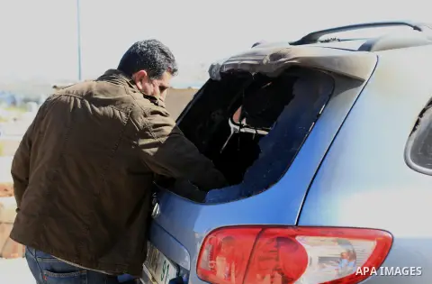 A Palestinian man inspects a damage car at al-Mughayir, east of Ramallah in the northern West Bank on March 5, 2015. Suspected Jewish extremists torched two cars and scrawled graffiti on a nearby wall in the West Bank vi...