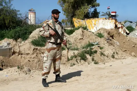 A member of Palestinian security forces stands guard on the border between Egypt and southern Gaza Strip, in Rafah on March 5, 2015. Gaza's border crossings will be reopened once control of them is handed over to the Pal...