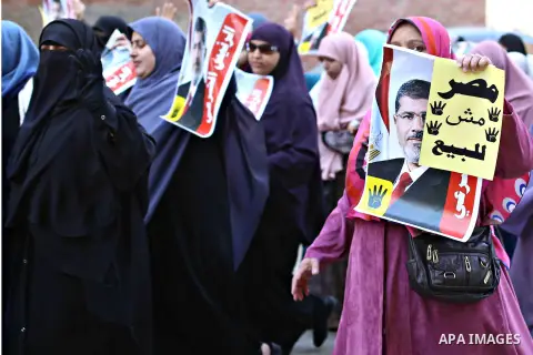 Egyptian supporters of Muslim Brotherhood and ousted president Mohammed Morsi, holds placards during a demonstration against the military rule, in al-Haram district, near Cairo March 6, 2015. Photo by Amr Sayed