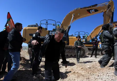 Israeli border policemen scuffle with Palestinian protesters as they clear a protest on land that Palestinians say was confiscated by Israel for Jewish settlements, near the West Bank town of Abu Dis near Jerusalem March...