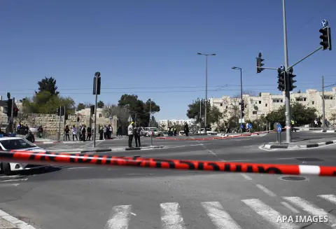 Israeli border guards stand near a car that ploughed into pedestrians in Jerusalem injuring several people, before its driver got out and tried to stab them, in an attack mirroring similar incidents last year, on March 6...