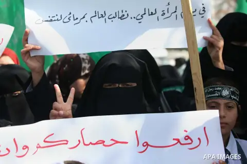 Palestinian women take part in a rally of Hamas supporters in front of the headquarters of the United Nations Relief and Works Agency (UNRWA) on the occasion of International Women's Day in Gaza City on March 8, 2015. Ph...