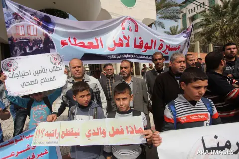 Palestinian employees of former Palestinian government take part a protest demanding their salaries to be paid, in front of the Legislative Council in Gaza city on March 10, 2015. Some 40,000 civil servants employed by t...