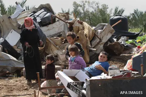Palestinians collect belongings near the rubble of their house that were demolished by the Israeli army, in the village of El-Jiftlik north the west bank city of jericho, on March 10, 2015. The owners of the house said t...