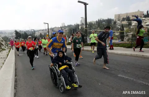 Athletes participate in the fifth international Jerusalem Marathon, March 13, 2015. Over 20,000 runners from some 60 countries took part in the annual sporting event on Friday, with tracks passing near the Old City, one...