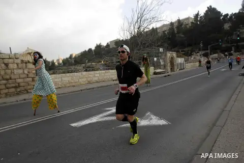 Athletes participate in the fifth international Jerusalem Marathon, March 13, 2015. Over 20,000 runners from some 60 countries took part in the annual sporting event on Friday, with tracks passing near the Old City, one...