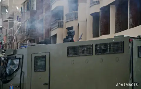 A member of Egyptian riot police stands guard on an armored vehicle during a demonstration organised by supporters of Muslim Brotherhood and ousted President Mohammed Morsi, against military rule, in the Cairo suburb of...
