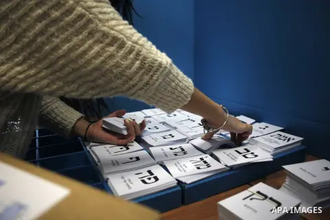 An Israeli woman casts her ballot at a polling station in the northern city of Haifa March 17, 2015. Millions of Israelis voted on Tuesday in a tightly fought election, with Prime Minister Benjamin Netanyahu facing an up...