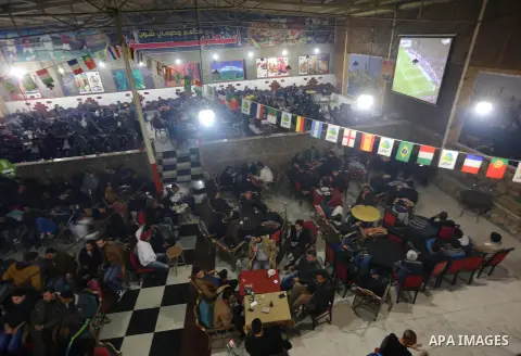 Palestinian youths watch a soccer match for Barcelona's team against Real Madrid team during the end of their Spanish first division "Clasico" soccer match at cafe, in Gaza city on March 22, 2015. FC Barcelona won 2-1 ag...