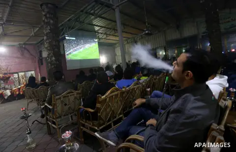 Palestinian youths watch a soccer match for Barcelona's team against Real Madrid team during the end of their Spanish first division "Clasico" soccer match at cafe, in Gaza city on March 22, 2015. FC Barcelona won 2-1 ag...