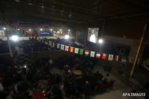 Palestinian youths watch a soccer match for Barcelona's team against Real Madrid team during the end of their Spanish first division "Clasico" soccer match at cafe, in Gaza city on March 22, 2015. FC Barcelona won 2-1 ag...
