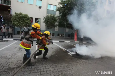 Palestinian Civil Defense members and students take part in a drill at a scene simulating a fire at University College of Applied Sciences by an Israeli air strike, in Gaza city March 24, 2015. Photo by Ashraf Amra