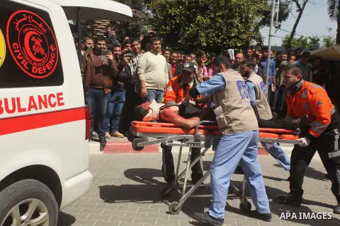 Palestinian Civil Defense members and students take part in a drill at a scene simulating a fire at University College of Applied Sciences by an Israeli air strike, in Gaza city March 24, 2015. Photo by Ashraf Amra