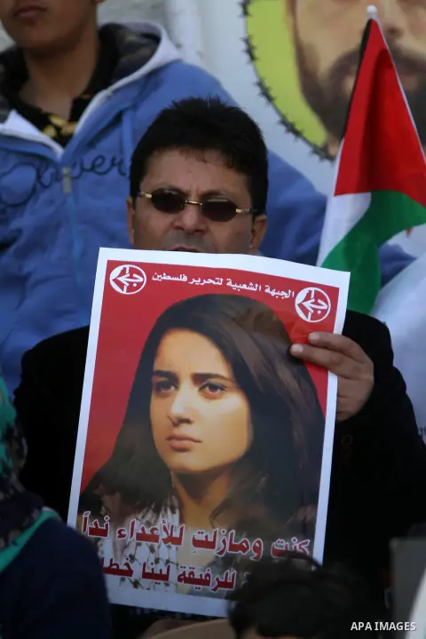 Palestinians take part in a protest demanding the release of their relatives prisoners held in Israeli jails, in front of Red cross office, in the West bank city of Ramallah, on March 24, 2015. Photo by Shadi Hatem
