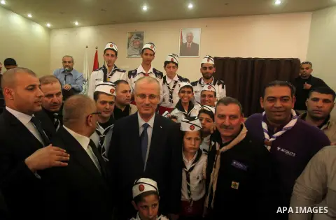 Palestinian prime minister Rami Hamdallah visits an orphanage during his visit to the Gaza Strip, in Gaza city on March 26, 2015. Hamdallah urged rival factions to set aside their differences, even as protesters gave him...