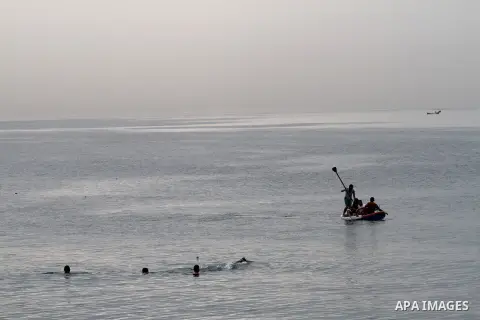 Palestinians ride a boat in the Mediterranean Sea off the coast of Gaza City as they enjoy a warm day March 27, 2015. Photo by Mohammed Asad
