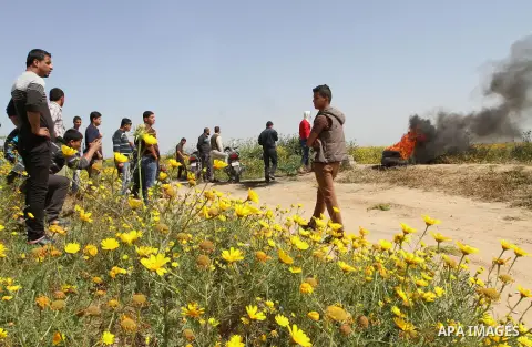 Palestinians burn tires during a rally marking Land day in Absan near the border between Israel and east of the town of Khan Yunis in the southern Gaza Strip March 30, 2015. The annual demonstrations mark the deaths of s...