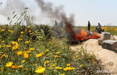 Palestinians burn tires during a rally marking Land day in Absan near the border between Israel and east of the town of Khan Yunis in the southern Gaza Strip March 30, 2015. The annual demonstrations mark the deaths of s...