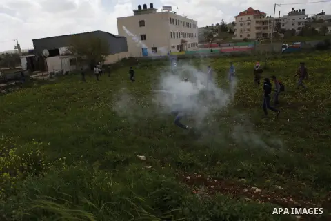 Palestinian protesters throw stones towards Israeli troops during clashes following a protest marking the Land Day and against Jewish settlements in the West Bank village of Silwad near Ramallah March 30, 2015. Palestini...