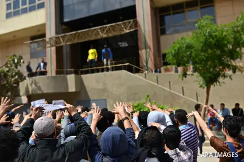 Egyptian students who support Muslim Brotherhood and ousted president Mohammed morsi hold banners and shout slogans during a protest in solidarity with Syrian people, at Cairo University on April 1, 2015. International d...