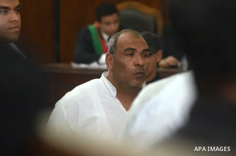 Egyptian defendants in the trial of US embassy violence stand in the court room during their trial in Cairo on April 2, 2015. The Cairo Criminal Court delayed the trial of 23 of members of Muslim Brotherhood accusing in...