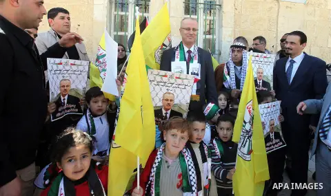 A picture released by the Palestinian Prime Minister office shows Palestinian Prime Minister Rami Hamdallah participating in protest of relatives of Palestinian prisoners in the Israeli jails, outside the Red Cross headq...
