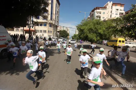 Palestinian boys take part in a marathon to mark the Palestinian Child Day, organized by Jawwal in Gaza city, on April 4, 2015. Photo by Ashraf Amra