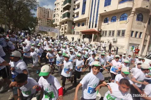 Palestinian boys take part in a marathon to mark the Palestinian Child Day, organized by Jawwal in Gaza city, on April 4, 2015. Photo by Ashraf Amra