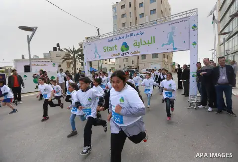 Palestinian boys take part in a marathon to mark the Palestinian Child Day, organized by Jawwal in the West Bank city of Ramallah, on April 4, 2015. Photo by Shadi Hatem