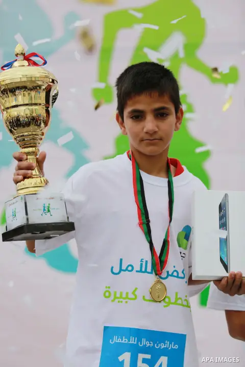 Palestinian boys take part in a marathon to mark the Palestinian Child Day, organized by Jawwal in the West Bank city of Ramallah, on April 4, 2015. Photo by Shadi Hatem