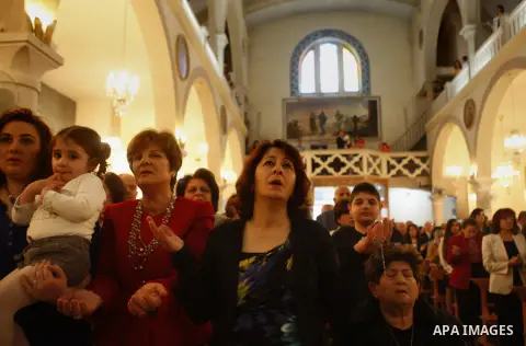 Palestinian Orthodox Christians attend the Palm Sunday mass at Latin Church in the West Bank city of Ramallah on April 5, 2015. Palm Sunday in many Christian churches symbolically marks the biblical account of the entry...